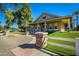 View of the community center building featuring manicured landscaping, stone accents, and sidewalk at 2643 E Tamarisk St, Gilbert, AZ 85296