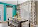 Bright dining area with a wooden table, modern chairs, and plantation shutters at 2643 E Tamarisk St, Gilbert, AZ 85296