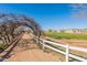 This property offers a farm area with an arched trellis and white fencing, enhancing its rural charm and potential at 2643 E Tamarisk St, Gilbert, AZ 85296