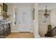 Bright foyer with a chandelier, wood floors, and a staircase leading upstairs at 2643 E Tamarisk St, Gilbert, AZ 85296