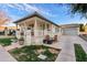 Beautiful home exterior featuring a covered porch, landscaped yard, and a long driveway leading to a garage at 2643 E Tamarisk St, Gilbert, AZ 85296