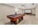 Spacious game room features a pool table and a large screen, perfect for entertaining guests at 2643 E Tamarisk St, Gilbert, AZ 85296