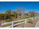 This property features a fenced garden area with raised beds and mature trees, perfect for gardening enthusiasts at 2643 E Tamarisk St, Gilbert, AZ 85296