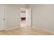 Hallway leading to a theater room, showcasing the wood floors and neutral color scheme at 2643 E Tamarisk St, Gilbert, AZ 85296