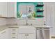 Bright kitchen featuring white cabinets, a farmhouse sink, and a window view at 2643 E Tamarisk St, Gilbert, AZ 85296