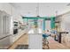 Open kitchen with white cabinets, a marble island, and stainless steel appliances at 2643 E Tamarisk St, Gilbert, AZ 85296