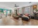 Open concept living room boasts a stylish sofa, shutters, and a view of the dining area at 2643 E Tamarisk St, Gilbert, AZ 85296