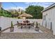 Outdoor dining area with a thatched umbrella, string lights, and stone pavers at 2643 E Tamarisk St, Gilbert, AZ 85296