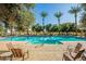 Enjoy the community pool area surrounded by palm trees and lounge chairs, offering a perfect spot for relaxation at 2643 E Tamarisk St, Gilbert, AZ 85296