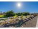 The property boasts a sprawling yard with fruit trees and white fencing, offering a serene and picturesque landscape at 2643 E Tamarisk St, Gilbert, AZ 85296