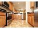 Well-lit kitchen features wooden cabinets, stainless steel appliances, and granite countertops at 26997 W Tonopah Dr, Buckeye, AZ 85396