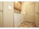 Laundry room with front-load washer and dryer, and storage cabinets at 26997 W Tonopah Dr, Buckeye, AZ 85396