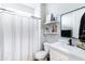Modern bathroom with a white vanity, black hardware, and a shower with striped curtain at 2819 N 28Th Pl, Phoenix, AZ 85008