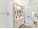 Modern bathroom with double vanity, stylish lighting, a marble-tiled shower, and a wooden stool at 2819 N 28Th Pl, Phoenix, AZ 85008
