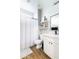 Bright bathroom featuring a white vanity, modern mirror, and shower with striped curtain at 2819 N 28Th Pl, Phoenix, AZ 85008