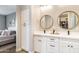 Bathroom double vanity with sleek fixtures, round mirrors, and storage cabinets, connecting to the main bedroom at 2819 N 28Th Pl, Phoenix, AZ 85008