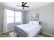 Cozy bedroom featuring a queen bed, large windows, a ceiling fan, and neutral decor at 2819 N 28Th Pl, Phoenix, AZ 85008