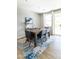 Modern dining room featuring a wood table, six chairs and a stylish blue rug, near sliding glass doors at 2819 N 28Th Pl, Phoenix, AZ 85008