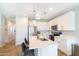 A stunning kitchen featuring a central island with barstool seating, stainless steel appliances, and sleek white cabinetry at 2819 N 28Th Pl, Phoenix, AZ 85008