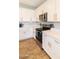 Well-appointed kitchen featuring stainless steel appliances, quartz countertops, stylish white cabinets and wood-look flooring at 2819 N 28Th Pl, Phoenix, AZ 85008