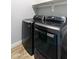 Convenient laundry room featuring side by side modern washer and dryer, and storage shelf for cleaning supplies at 2819 N 28Th Pl, Phoenix, AZ 85008