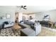 Bright living room with gray sofa, modern decor, and an open view to the dining area and kitchen at 2819 N 28Th Pl, Phoenix, AZ 85008
