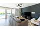 Inviting living room with a gray sectional, black accent wall, and views of the backyard swimming pool at 2819 N 28Th Pl, Phoenix, AZ 85008