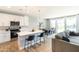 Bright, open-concept living space with kitchen, dining area, and living room featuring recessed lighting and sliding glass doors to backyard at 2819 N 28Th Pl, Phoenix, AZ 85008
