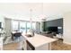 Bright, open-concept living space featuring a modern kitchen with large island, adjacent to the dining and living area at 2819 N 28Th Pl, Phoenix, AZ 85008