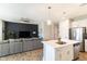 Bright, open-concept living space featuring a modern kitchen with island and sink, an adjacent living room and an accent wall at 2819 N 28Th Pl, Phoenix, AZ 85008