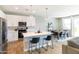 Bright, open-concept living space with kitchen, dining area, and living room featuring recessed lighting and sliding glass doors to backyard at 2819 N 28Th Pl, Phoenix, AZ 85008