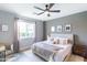 Bright main bedroom with a ceiling fan, large window, and neutral tones, creating a relaxing atmosphere at 2819 N 28Th Pl, Phoenix, AZ 85008