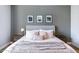 Calm main bedroom showcasing a large bed with neutral bedding, framed prints, and soft lighting at 2819 N 28Th Pl, Phoenix, AZ 85008