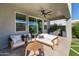 Outdoor patio featuring a fan, comfy seating, and views of the meticulously landscaped backyard at 2819 N 28Th Pl, Phoenix, AZ 85008