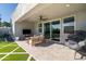 Covered patio with an outdoor fan, comfortable seating, and views of the pool and manicured backyard at 2819 N 28Th Pl, Phoenix, AZ 85008