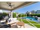 Inviting covered patio with plush seating and clear views of the sparkling backyard pool and manicured yard at 2819 N 28Th Pl, Phoenix, AZ 85008