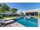Backyard pool featuring sun loungers, built in hot tub and luxurious lounge area on the covered patio of a modern home at 2819 N 28Th Pl, Phoenix, AZ 85008