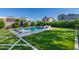 A beautiful backyard with a pool, lounge chairs, artificial grass, and privacy hedges creating a serene outdoor space at 2819 N 28Th Pl, Phoenix, AZ 85008