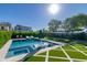 Beautiful backyard featuring a sparkling swimming pool with in-pool loungers and geometric turf designs at 2819 N 28Th Pl, Phoenix, AZ 85008