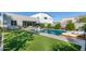 A luxurious pool with sunbeds and a covered patio that creates an idyllic backyard oasis with artificial grass at 2819 N 28Th Pl, Phoenix, AZ 85008