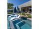 Backyard pool area with a relaxing spa, lounge chairs, artificial grass, and covered patio for outdoor entertaining at 2819 N 28Th Pl, Phoenix, AZ 85008