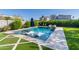 Inviting pool area with in-pool seating, lush landscaping, and a well-manicured lawn for outdoor enjoyment at 2819 N 28Th Pl, Phoenix, AZ 85008