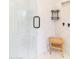 Contemporary shower with marble-style tiles, a frameless glass door, and a built-in shelf for convenience at 2819 N 28Th Pl, Phoenix, AZ 85008
