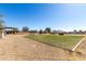Expansive backyard with green lawn, playset, trampoline, hot tub, and ample space for outdoor fun at 28213 N Holly Rd, San Tan Valley, AZ 85143