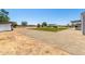 Large backyard with small green lawn, playset and hot tub area at 28213 N Holly Rd, San Tan Valley, AZ 85143