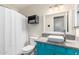Bathroom featuring vibrant blue vanity, vessel sink, decorative mirror and tiled floors at 28213 N Holly Rd, San Tan Valley, AZ 85143
