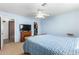 Bedroom featuring blue walls, ceiling fan, and walk in closet at 28213 N Holly Rd, San Tan Valley, AZ 85143