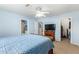 Bedroom featuring blue walls, ceiling fan, and walk in closet at 28213 N Holly Rd, San Tan Valley, AZ 85143
