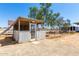 Exterior view of rustic chicken coop with picket fence and surrounding pens at 28213 N Holly Rd, San Tan Valley, AZ 85143