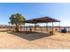 Horse shelter with metal roof and surrounding fenced area at 28213 N Holly Rd, San Tan Valley, AZ 85143